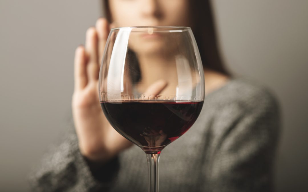 an emotional drinker trying to say no to a glass of wine.